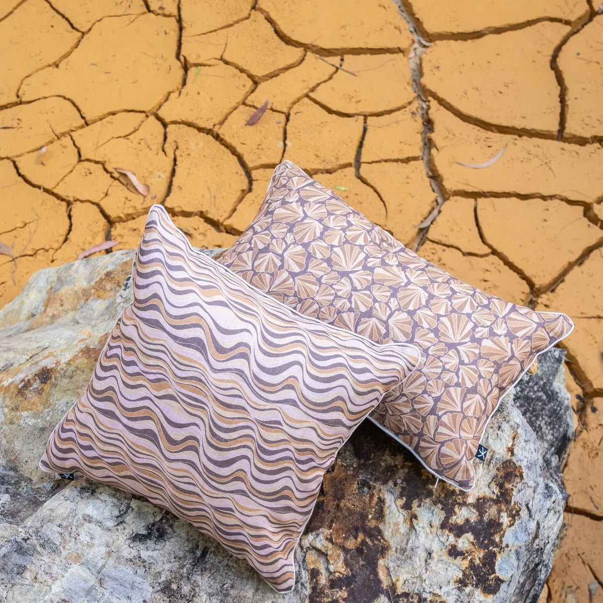 Claytons Straddie Stripe and Shells linen cushion covers styled outdoors on rock