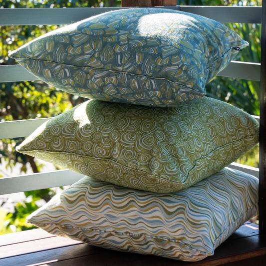 Stack of three Mangrove outdoor cushions showing Pipi, Growth Rings and Straddie Stripe prints.