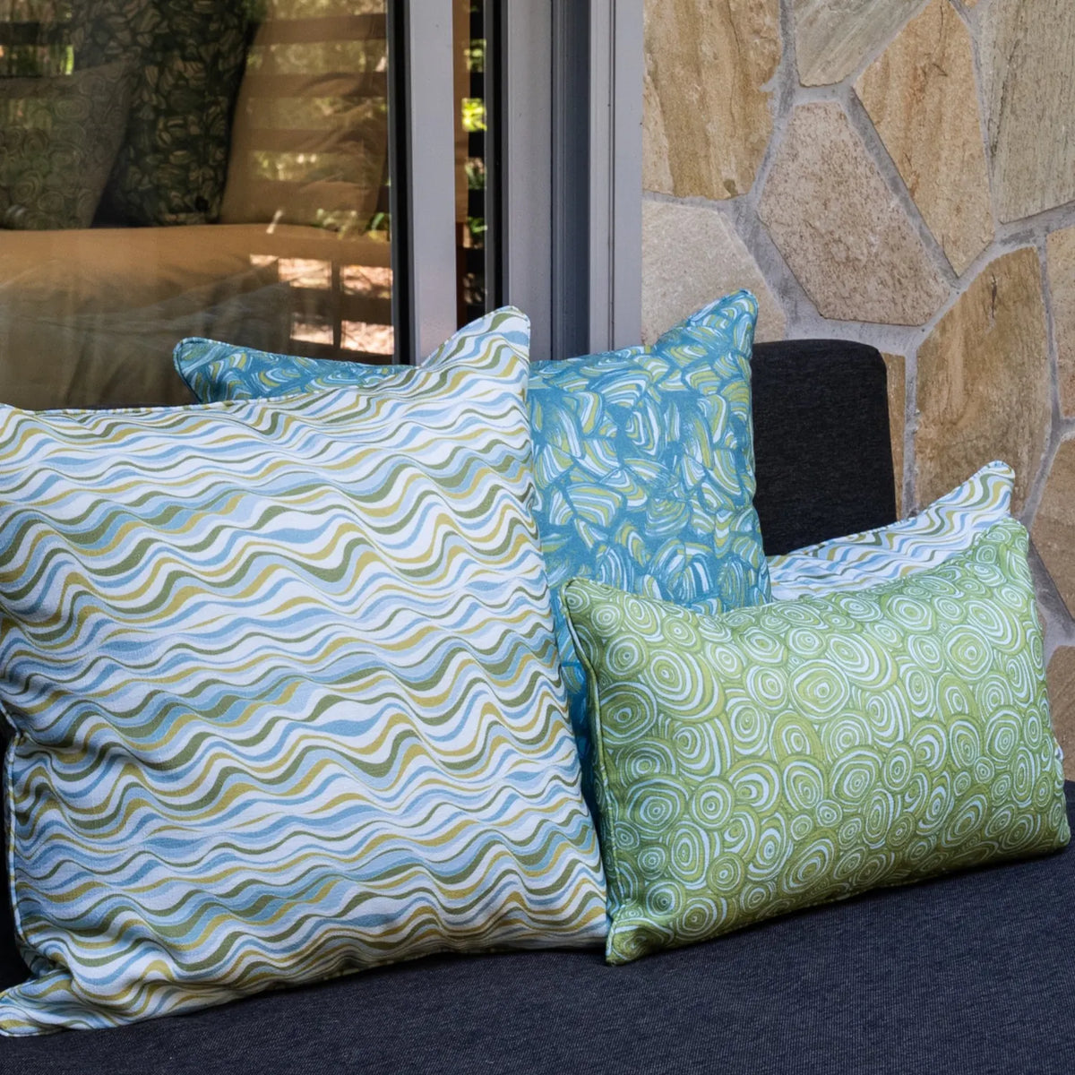 Mangrove cushion collection styled on an outdoor lounge with square and lumbar cushions in mixed prints.